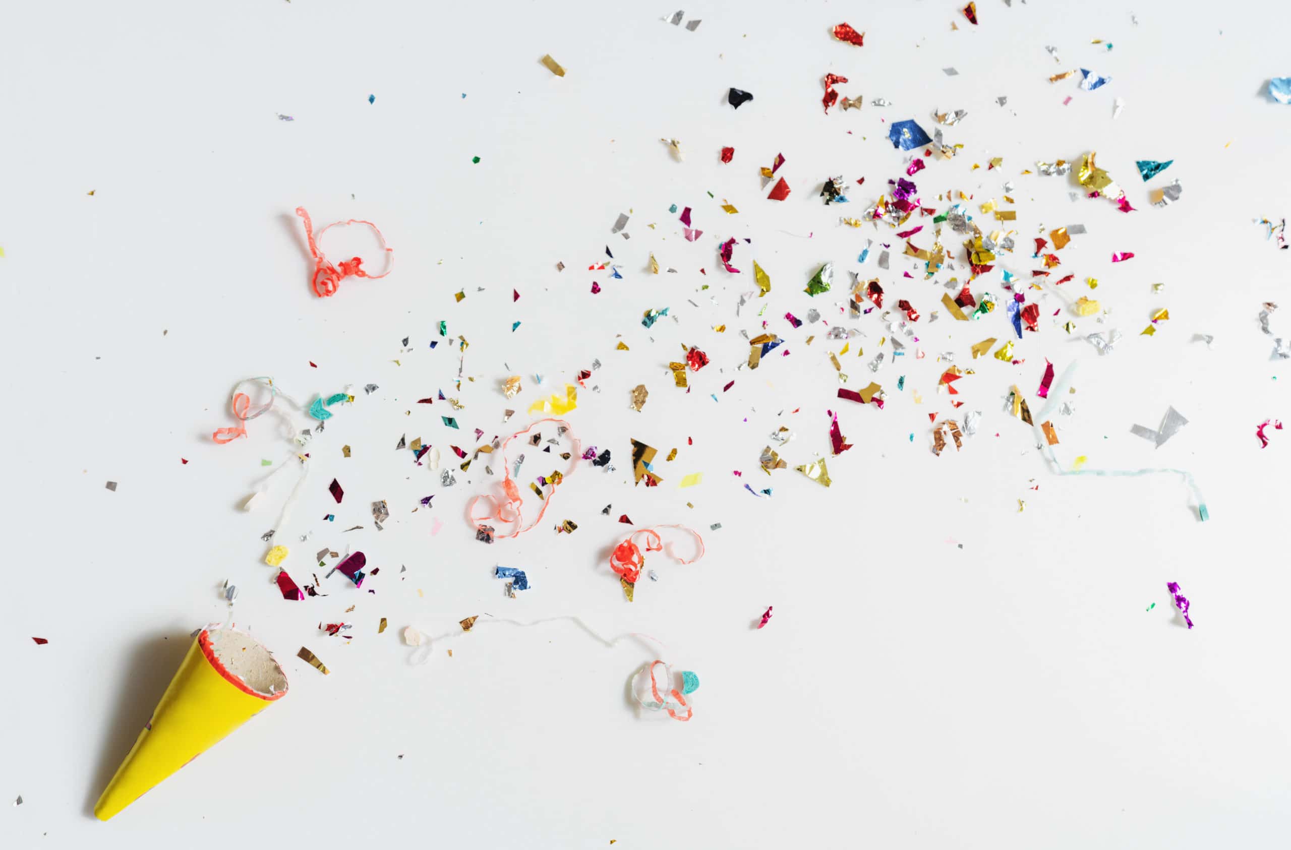 Exploding party popper on white background